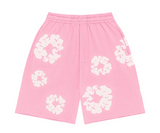 Denim Tears pink shorts with white cotton wreath graphic print.