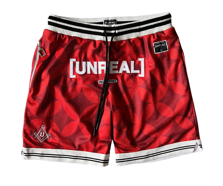UNREAL Team Shorts piros színben, mintás mintával és hímzett logóval.