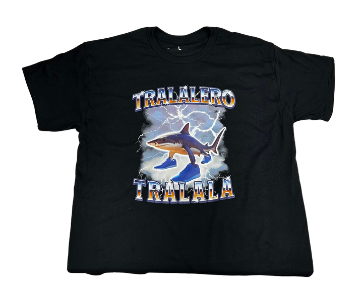 Black t-shirt with a shark wearing sneakers and lightning graphics.
