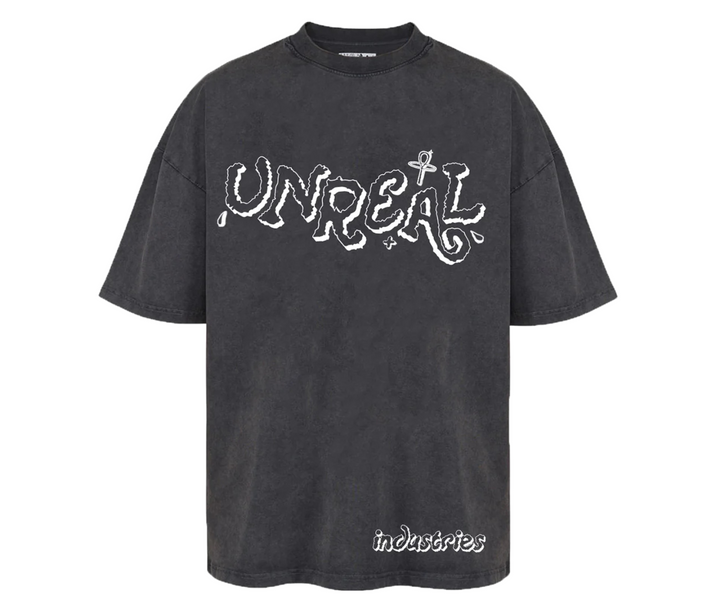 Washed black t-shirt with white "UNREAL" graphic and "industries" text.