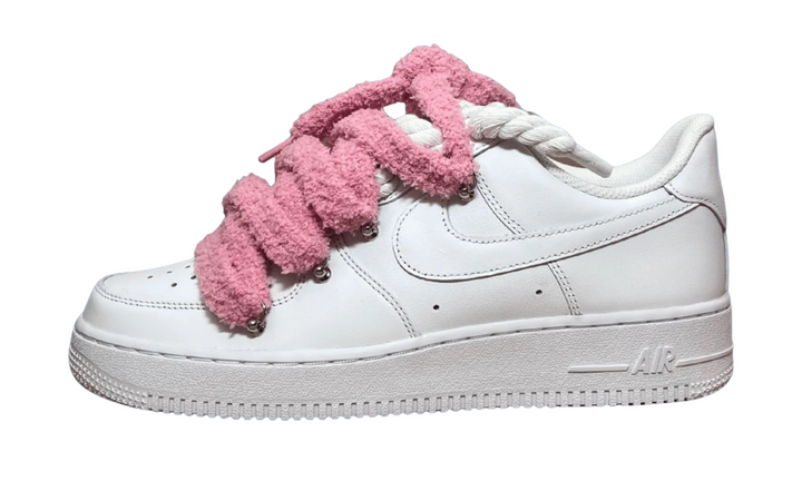 White Nike Air Force 1 sneakers with pink fuzzy laces.