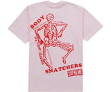 Pink Supreme t-shirt with a red skeleton graphic and text.