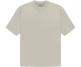 Essentials Seal Tee in beige with embossed logo.
