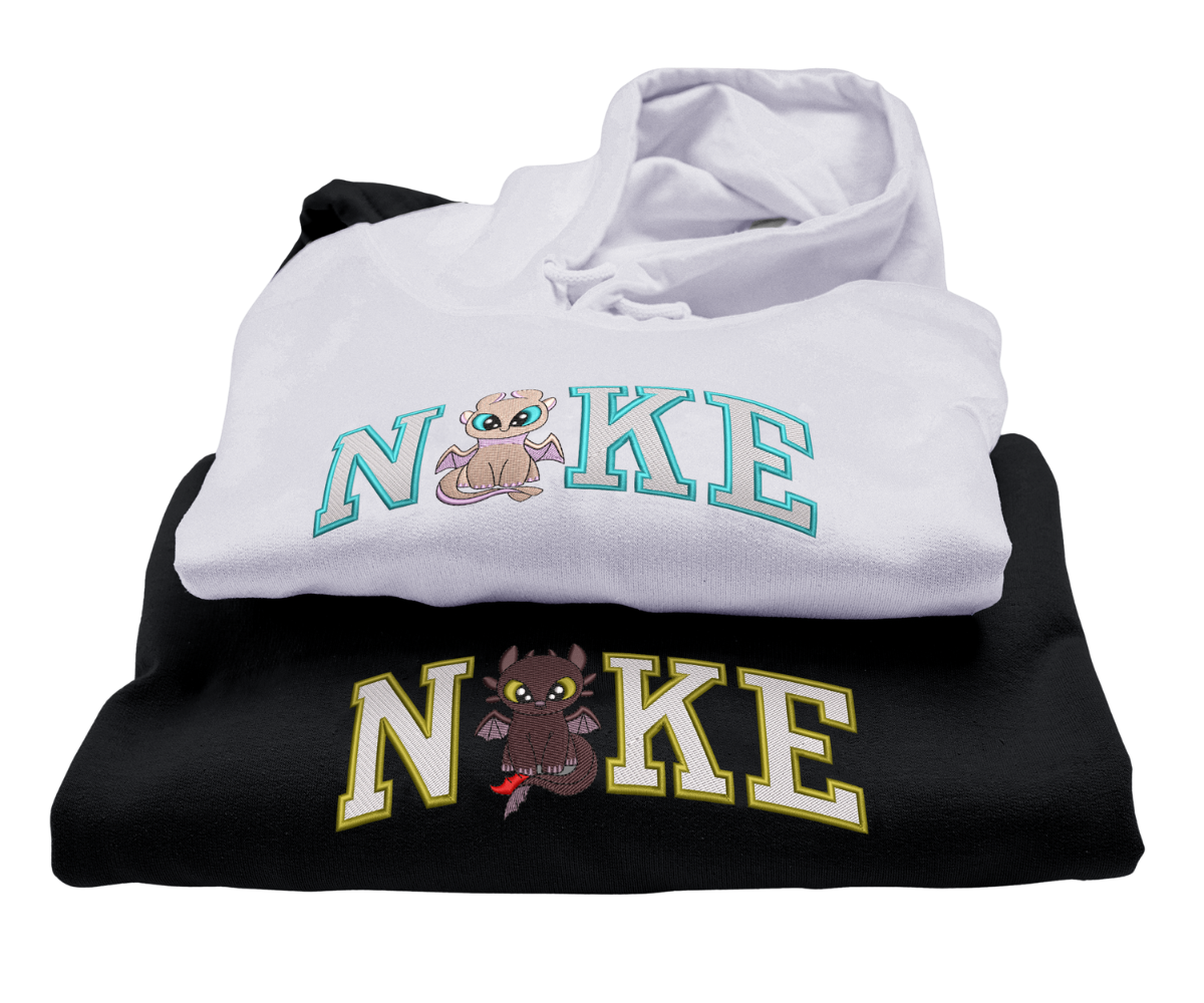 Két pulóver, egy fehér és egy fekete, sárkányhímzéssel.