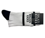 Balázs Kicks white socks with black stripes and logo tag.