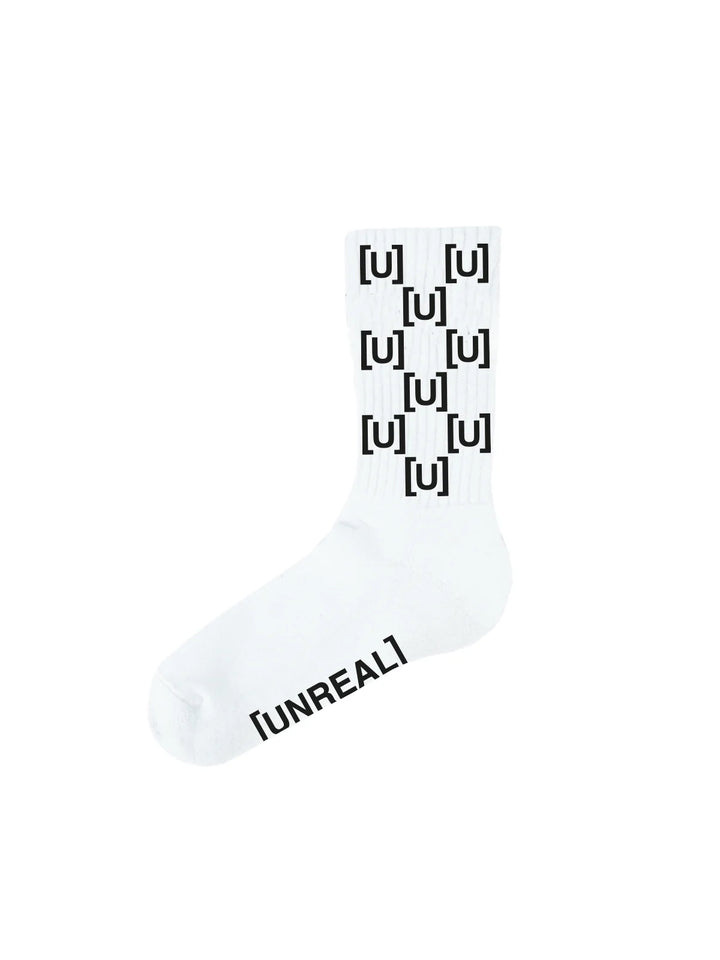 White socks with black repeating U print and UNREAL text.