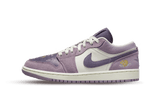 Air Jordan 1 Low Unity sneaker in purple and white with "unity" text.