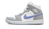 Air Jordan 1 Mid Aluminium Wolf Grey sneaker with white and grey overlays and a blue swoosh.