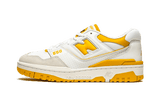 New Balance 550 Sea Salt Varsity Gold low top sneaker with white leather and yellow accents.